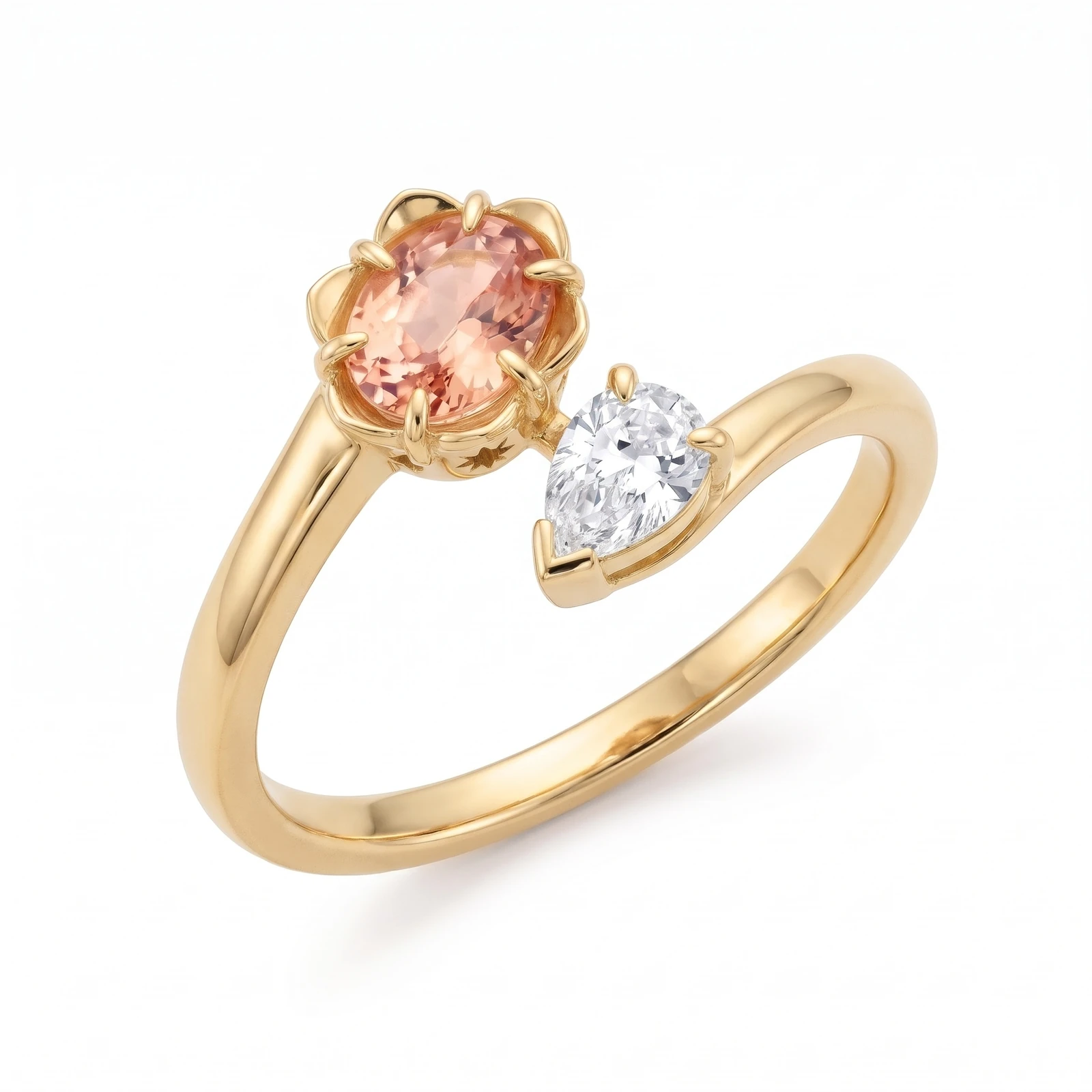 Bustan Shokufeh engagement ring in 18ct yellow gold: a peach sapphire oval in a blossom setting of rounded petals beside a colourless diamond pear, on a smooth branch whose two ends pass each other.